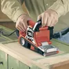 A person is using a belt sander on a wooden surface. Anteprima dell’immagine prodotto