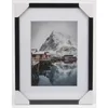 A framed picture of a snowy landscape with red houses. Anteprima dell’immagine prodotto