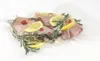 A vacuum-sealed package of raw chicken with lemon slices, rosemary, and chili peppers. Produktbild-Vorschau
