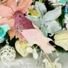 A close-up of a decorative bird ornament on a Christmas tree. Náhľad obrázku produktu