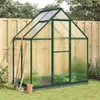 A greenhouse with gardening tools and pots in a garden setting. Produktbild-Vorschau
