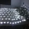 A bed covered in white string lights. Náhled obrázku produktu