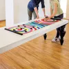 Two people playing a colorful curling game on a table. Produktbild-Vorschau