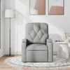 A gray fabric recliner chair is shown in a room with a floor lamp and artwork on the wall. Produktbild-Vorschau