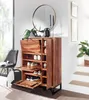 A wooden shoe cabinet with several compartments is shown in a hallway or living room setting, next to a chair and a staircase. A mirror hangs on the wall above the cabinet. Produktbild-Vorschau
