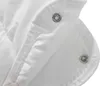 A close-up view of a white quilted fabric with metal snap fasteners. Produktbild-Vorschau