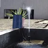 A solar-powered water pump with a solar panel and a plant in a pot, set up in a small water feature. Náhled obrázku produktu