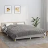 A bedroom scene with a bed, blanket, and artwork. Produktbild-Vorschau