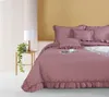 A bedroom scene with a bed, side table, and lamp. Produktbild-Vorschau