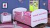 A child's bedroom with a pink and white bed, a nightstand, and a rug. Anteprima dell’immagine prodotto