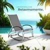 A rocking lounge chair is placed on a patio next to a swimming pool with palm trees and the ocean in the background. Náhled obrázku produktu