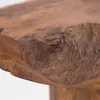 A close-up view of the textured surface of a wooden stool. Náhľad obrázku produktu