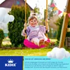 A young girl is happily swinging on a pink swing in a backyard setting. Produktbild-Vorschau