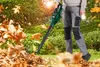 A person is using a leaf blower in a garden with fallen leaves. Náhľad obrázku produktu