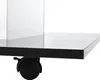 A close-up view of a black table with a white panel and a black wheel. Voir les images du produit