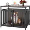 A dog is inside a wooden and metal dog crate that doubles as a side table. The table top has decorative items on it. Podgląd zdjęcia produktu