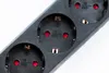 A close-up shot of a black power strip with three outlets. Produktbild-Vorschau