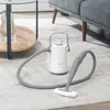 A white and gray steam cleaner is placed on a rug next to a sofa and a coffee table. Náhľad obrázku produktu