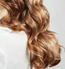 Close-up of a person's wavy, reddish-brown hair. Anteprima dell’immagine prodotto
