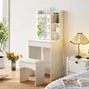 A white vanity table with a lighted mirror and a stool, set up in a bedroom next to a nightstand and bed. Voir les images du produit