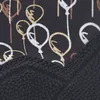A close-up view of the top portion of a black shoe with a patterned fabric lining. Produktbild-Vorschau