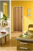 A room interior with a folding door, a table with food, and shelves with decorative items. Produktbild-Vorschau