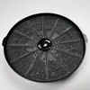 A round black charcoal filter with a metal mesh screen. Produktbild-Vorschau