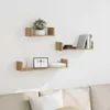 Three wooden shelves mounted on a white wall above a sofa. Produktbild-Vorschau