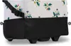 A close-up view of the bottom section of a wheeled bag with a floral pattern. Voir les images du produit