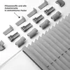 A collection of pleated blind components and a section of a pleated blind are laid out on a white surface. Produktbild-Vorschau