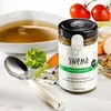 A jar of Swema vegetable broth is displayed next to a bowl of broth, a spoon, and fresh ingredients like tomatoes and carrots. Anteprima dell’immagine prodotto