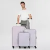 A man stands behind three suitcases of varying sizes. Produktbild-Vorschau