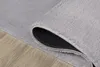 A close-up view of a gray rug, showing the texture and the non-slip backing. Produktbild-Vorschau