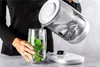 A person is pouring hot water from a ZWILLING electric kettle into a glass with mint leaves. Náhled obrázku produktu