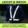 A person wearing a reflective safety vest outdoors. Produktbild-Vorschau