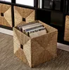 A woven basket filled with records is placed on a carpet in front of a black shelf unit. Produktbild-Vorschau