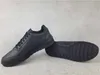 A pair of black Puma sneakers are displayed on a light gray surface. Voir les images du produit