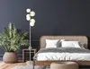 A bedroom scene with a bed, a plant, and a floor lamp. Produktbild-Vorschau