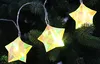 A close-up shot of star-shaped LED lights on a Christmas tree. Produktbild-Vorschau