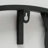 A close-up view of a black metal wall clock's mounting bracket. Anteprima dell’immagine prodotto