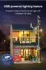 A model of a Japanese tea shop at night, with lights on inside and a street lamp. Produktbild-Vorschau