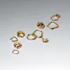 A collection of gold earrings arranged on a light gray background. Produktbild-Vorschau