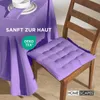 A purple tablecloth and a purple chair cushion are shown on a wooden chair. Náhled obrázku produktu
