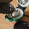 A close-up of an open waffle maker with its top plate removed. Náhled obrázku produktu