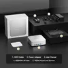 A display of a mini PC and its accessories, laid out on a dark surface. Produktbild-Vorschau