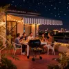 A group of friends enjoying a barbecue on a balcony at night with a city skyline in the background. Náhled obrázku produktu