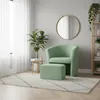 A mint green armchair and ottoman are placed in a well-lit room with a large window and sheer curtains. Produktbild-Vorschau