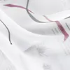 A close-up of a white sheer fabric with a printed pattern of text and abstract lines. Produktbild-Vorschau