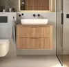 A modern bathroom vanity with a sink and faucet, next to a toilet and shower. Produktbild-Vorschau