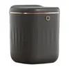 A dark gray automatic trash can with a copper trim and a small circular button on the front. Produktbild-Vorschau